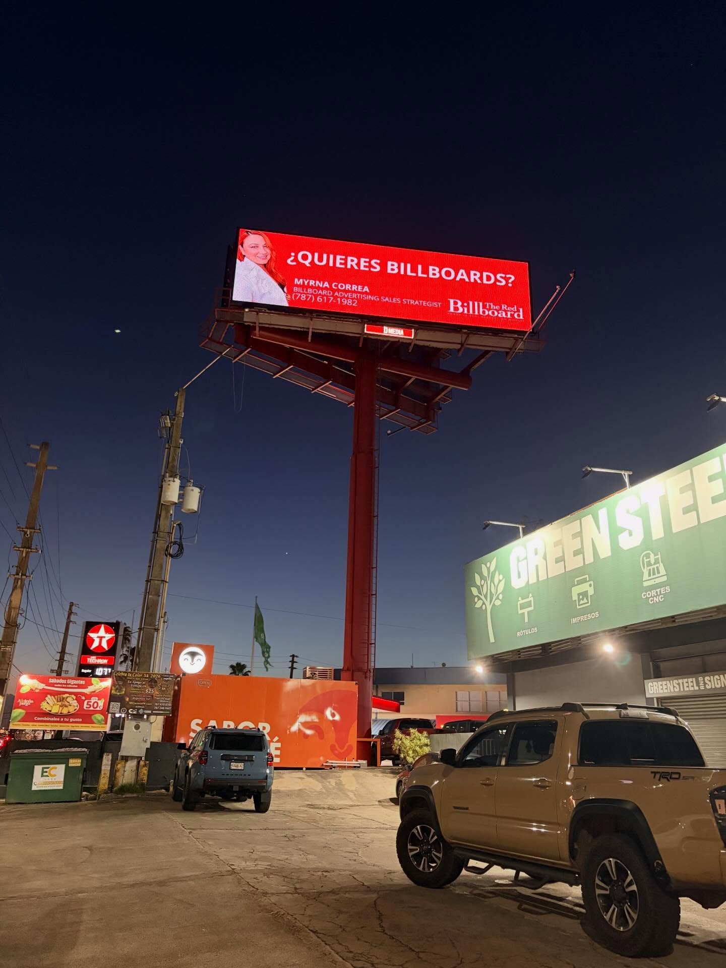 The Red Billboard campaign displayed on a billboard at night